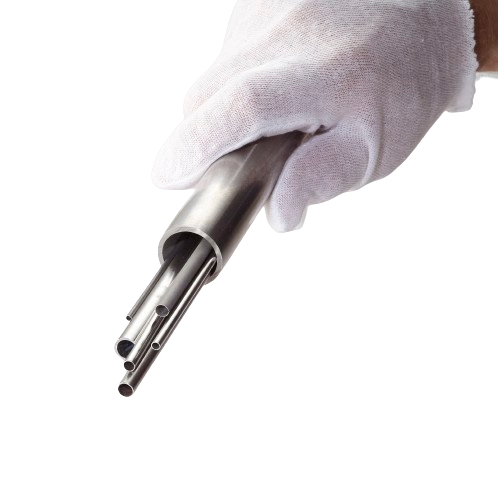 Gloved hand holding a stainless steel multi-barrel nozzle with multiple hollow tubes.